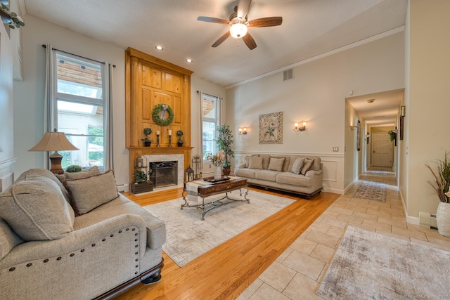 425 Pattonwood Dr, Southington, CT 06489 - living area with a ceiling fan, a fireplace with raised hearth, plenty of natural light, recessed lighting, and crown molding