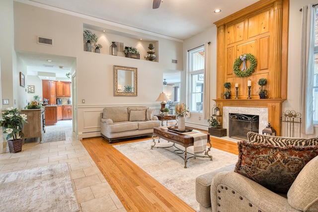425 Pattonwood Dr, Southington, CT 06489 - living room with crown molding, a fireplace, light wood-type flooring, wainscoting, and recessed lighting