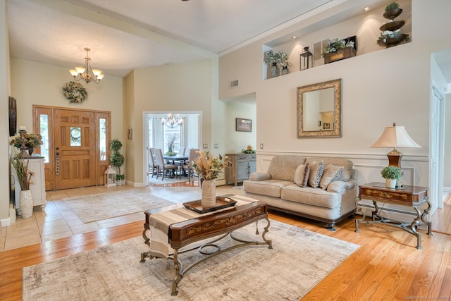 425 Pattonwood Dr, Southington, CT 06489 - living area with a chandelier, a high ceiling, wood finished floors, and baseboard heating