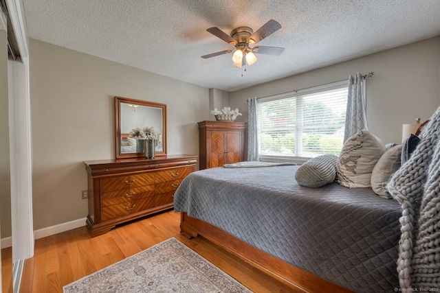 425 Pattonwood Dr, Southington, CT 06489 - bedroom with light wood-style floors, a textured ceiling, and a ceiling fan
