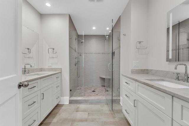 66 High St Unit 36, Guilford, CT 06437 - bathroom with two vanities, a shower stall, and recessed lighting