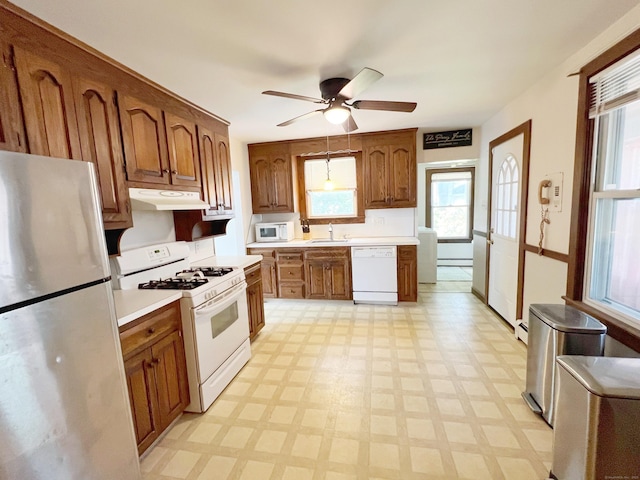 46 Glenwood St, Manchester, CT 06040 - kitchen with white appliances, under cabinet range hood, brown cabinets, light countertops, and light floors