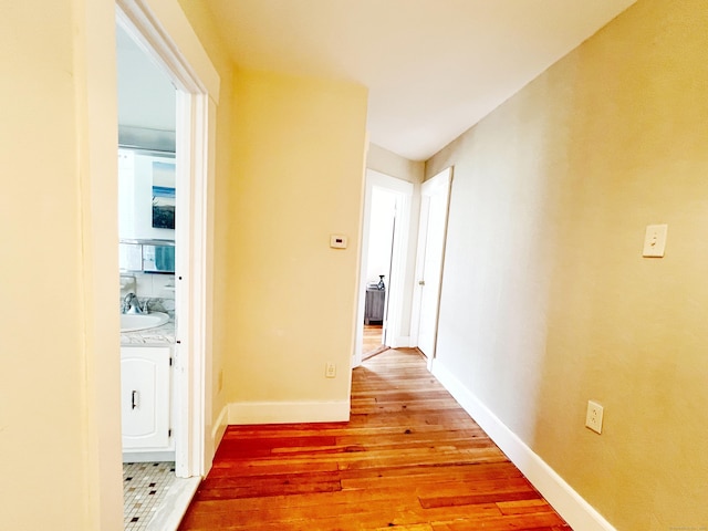 46 Glenwood St, Manchester, CT 06040 - hallway with light wood-style floors and a sink