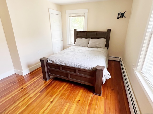 46 Glenwood St, Manchester, CT 06040 - bedroom with a baseboard heating unit and light wood-style floors