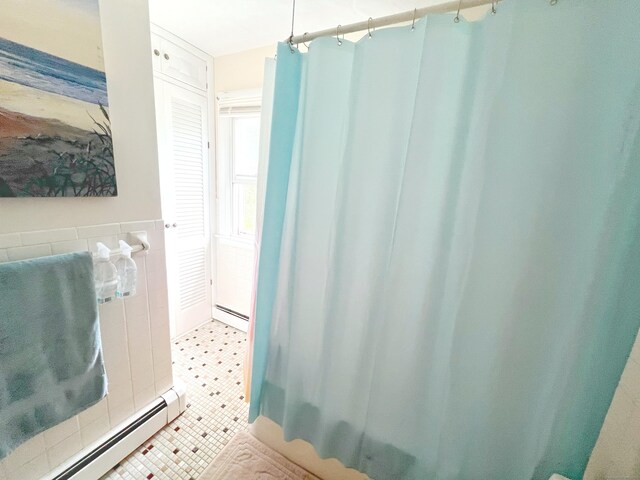 46 Glenwood St, Manchester, CT 06040 - bathroom with baseboard heating, a shower with curtain, tile patterned flooring, and tile walls