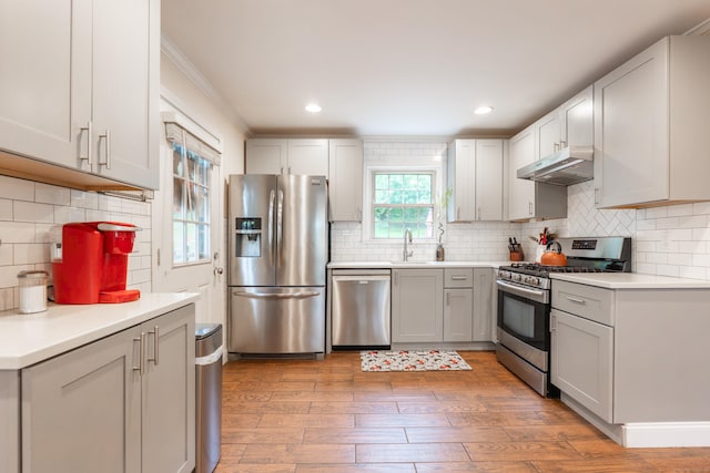 28 Hope Hill Rd, Wallingford, CT 06492 - kitchen with stainless steel appliances, under cabinet range hood, light wood finished floors, decorative backsplash, and recessed lighting
