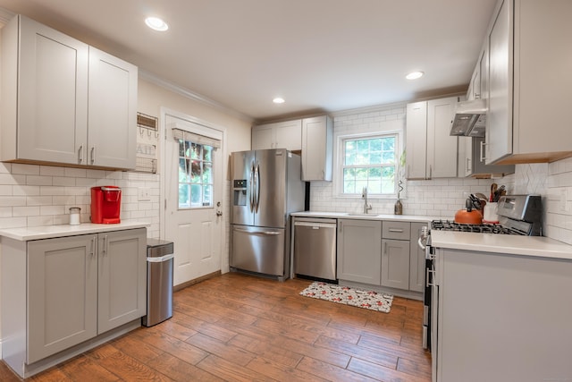 28 Hope Hill Rd, Wallingford, CT 06492 - kitchen with stainless steel appliances, light countertops, decorative backsplash, wood finished floors, and crown molding