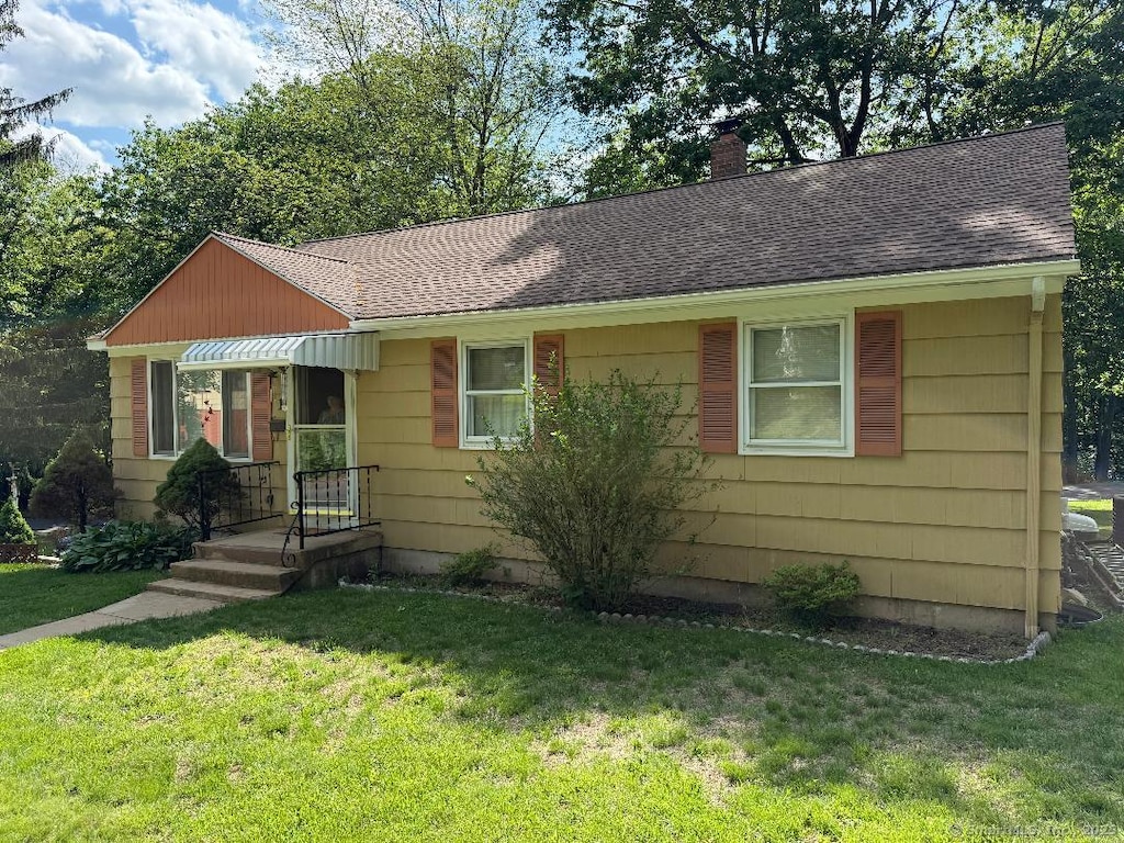 19 Benedict St, Plymouth, CT 06786 - view of front of property with a chimney, a shingled roof, and a front yard