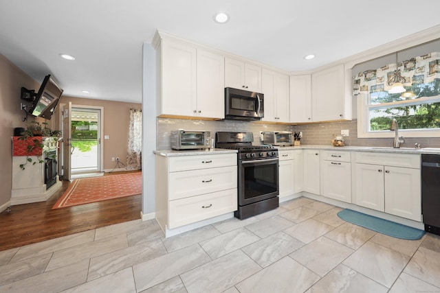 19 Benedict St, Plymouth, CT 06786 - kitchen featuring appliances with stainless steel finishes, decorative backsplash, recessed lighting, white cabinetry, and light marble finish floors