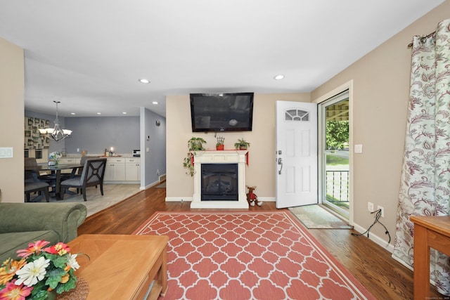 19 Benedict St, Plymouth, CT 06786 - living area featuring wood finished floors, recessed lighting, a chandelier, and a glass covered fireplace