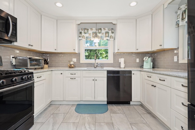 19 Benedict St, Plymouth, CT 06786 - kitchen with appliances with stainless steel finishes, light marble finish flooring, white cabinetry, recessed lighting, and decorative backsplash