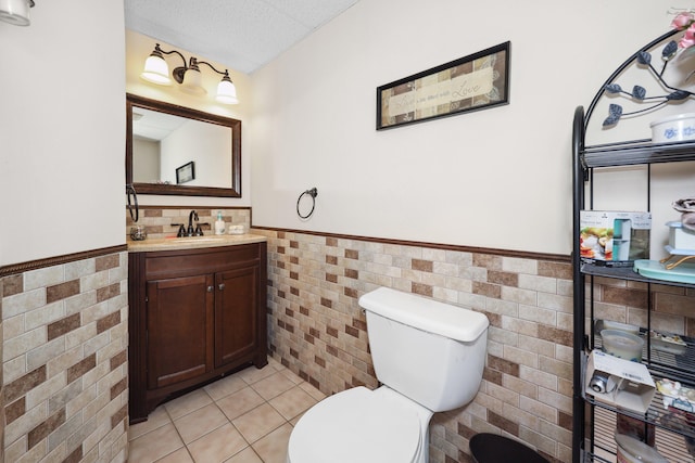 19 Benedict St, Plymouth, CT 06786 - half bath with a wainscoted wall, tile walls, vanity, and tile patterned floors