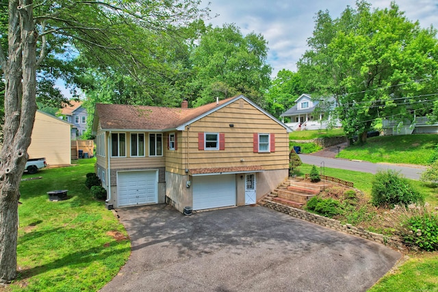 19 Benedict St, Plymouth, CT 06786 - view of front of house featuring asphalt driveway, a garage, a front yard, and a chimney