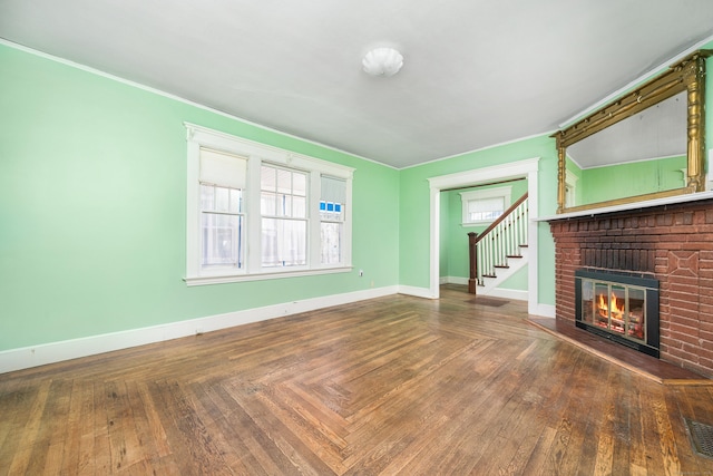 43 Quentin St, Hamden, CT 06517 - unfurnished living room featuring a brick fireplace, stairway, and crown molding
