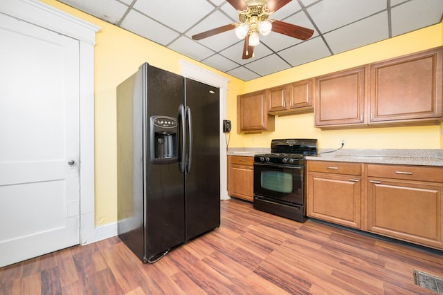 43 Quentin St, Hamden, CT 06517 - kitchen featuring black appliances, light countertops, a ceiling fan, a paneled ceiling, and wood finished floors