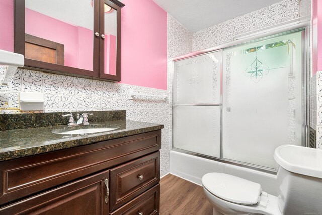 43 Quentin St, Hamden, CT 06517 - bathroom featuring enclosed tub / shower combo, vanity, wood finished floors, and decorative backsplash