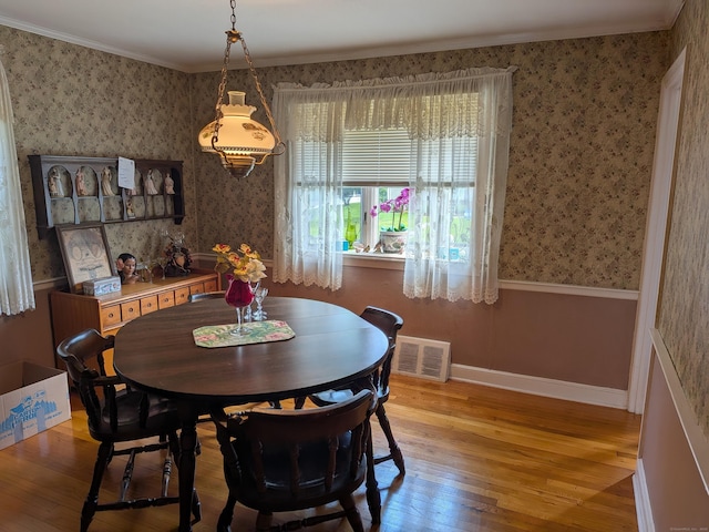 35 Chevvy St, Stratford, CT 06614 - dining space with light wood-type flooring, wallpapered walls, and crown molding
