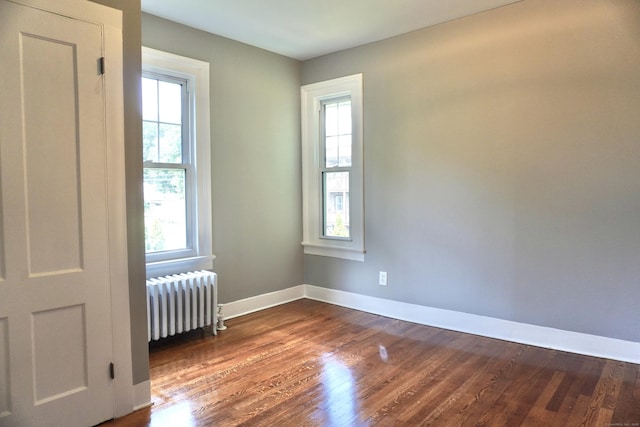 575 S Main St, Naugatuck, CT 06770 - spare room featuring radiator heating unit, healthy amount of natural light, and dark wood-type flooring