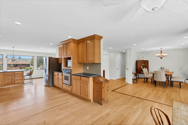 224 Neptune Dr, Groton, CT 06340 - kitchen with appliances with stainless steel finishes, light wood-style flooring, recessed lighting, a chandelier, and pendant lighting