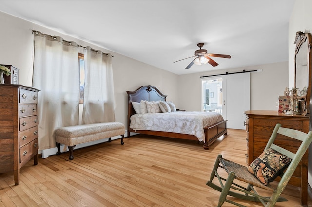 224 Neptune Dr, Groton, CT 06340 - bedroom with light wood finished floors, a barn door, and ceiling fan