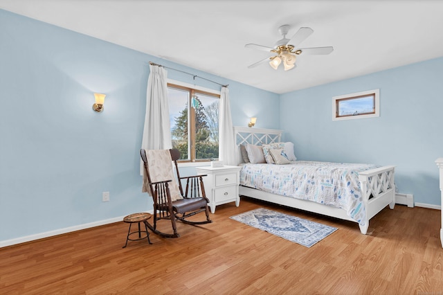 224 Neptune Dr, Groton, CT 06340 - bedroom with wood finished floors, baseboards, a baseboard heating unit, and ceiling fan