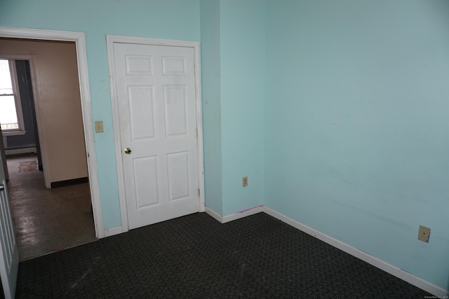 71 Martin St, Hartford, CT 06120 - unfurnished bedroom featuring baseboard heating and dark colored carpet