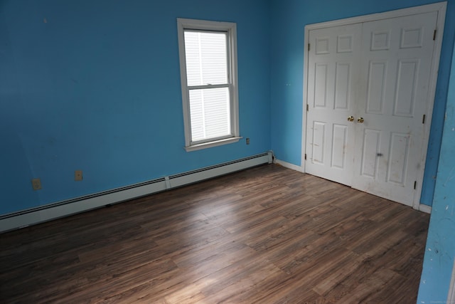 71 Martin St, Hartford, CT 06120 - unfurnished bedroom with baseboard heating, dark wood-type flooring, and a closet