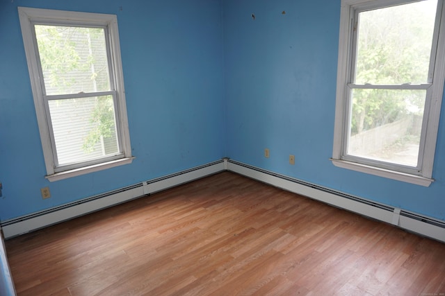 71 Martin St, Hartford, CT 06120 - empty room featuring light wood-type flooring, healthy amount of natural light, and a baseboard radiator