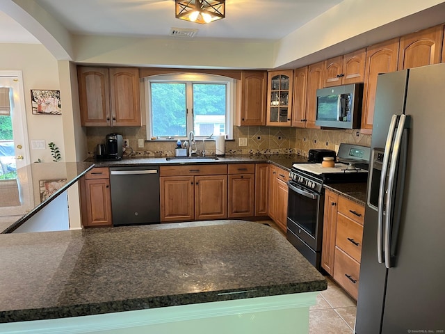 15 Great Meadow Rd, Danbury, CT 06811 - kitchen with stainless steel appliances, tasteful backsplash, glass insert cabinets, and arched walkways