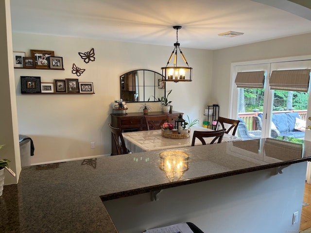 15 Great Meadow Rd, Danbury, CT 06811 - kitchen featuring a chandelier, a breakfast bar area, arched walkways, and decorative light fixtures
