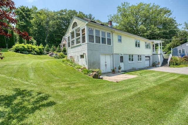 135 Jackson St, Torrington, CT 06790 - view of front of property featuring a chimney, driveway, a front yard, stairway, and a patio