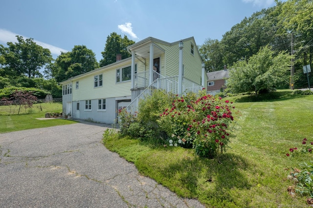135 Jackson St, Torrington, CT 06790 - view of front of property with a front lawn, asphalt driveway, stairs, and a chimney