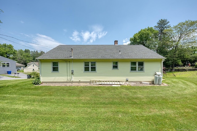 135 Jackson St, Torrington, CT 06790 - rear view of house with a lawn, a chimney, and a shingled roof