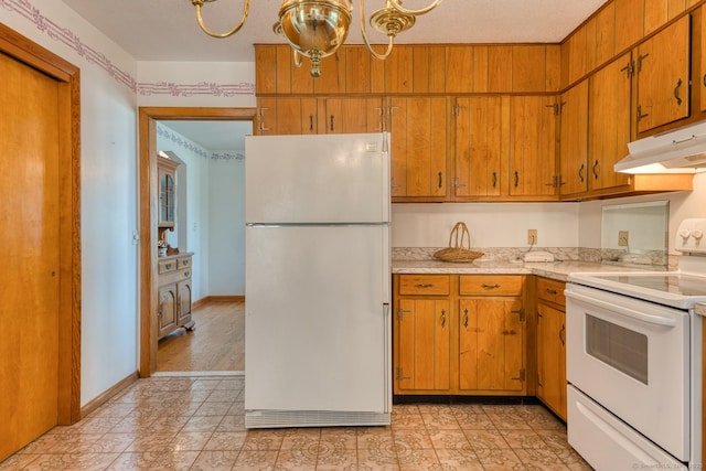 135 Jackson St, Torrington, CT 06790 - kitchen with white appliances, under cabinet range hood, light countertops, and brown cabinetry