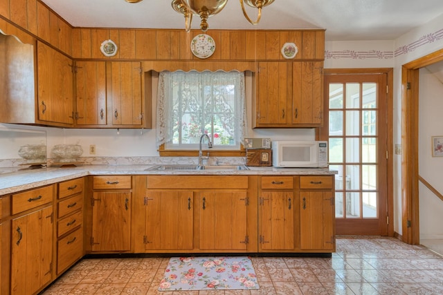 135 Jackson St, Torrington, CT 06790 - kitchen with white microwave, light countertops, and brown cabinetry