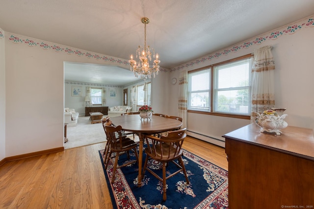 135 Jackson St, Torrington, CT 06790 - dining area featuring baseboard heating, a chandelier, and light wood-type flooring