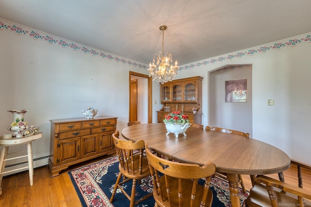 135 Jackson St, Torrington, CT 06790 - dining area featuring a chandelier, a baseboard radiator, and light wood-style floors