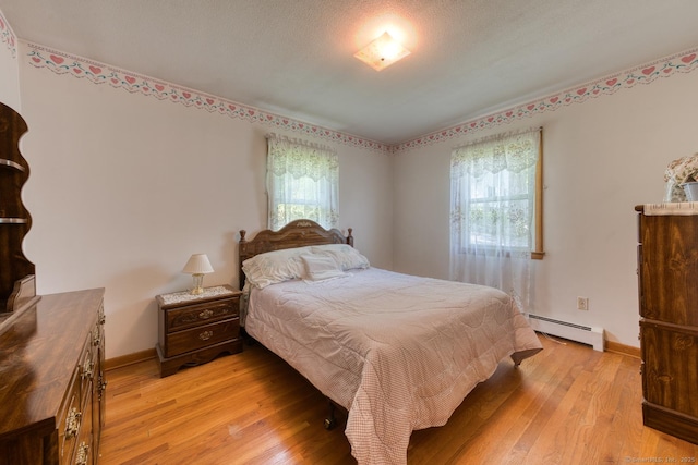 135 Jackson St, Torrington, CT 06790 - bedroom with a baseboard radiator, multiple windows, and light wood finished floors
