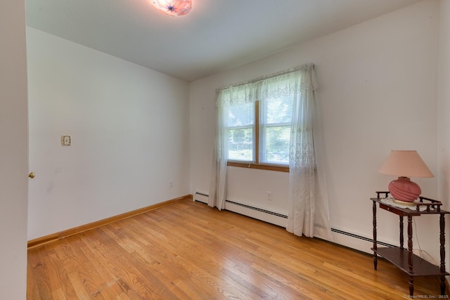 135 Jackson St, Torrington, CT 06790 - spare room with light wood-style floors and a baseboard heating unit