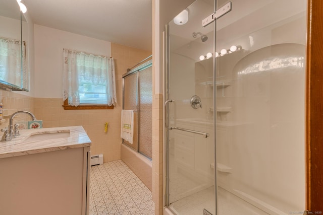 135 Jackson St, Torrington, CT 06790 - full bathroom featuring a baseboard heating unit, vanity, tile walls, bath / shower combo with glass door, and wainscoting