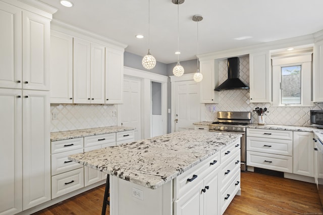 30 Cleveland Rd, New Haven, CT 06515 - kitchen featuring wall chimney range hood, appliances with stainless steel finishes, backsplash, white cabinetry, and a kitchen island