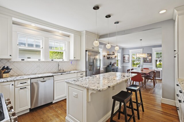 30 Cleveland Rd, New Haven, CT 06515 - kitchen with appliances with stainless steel finishes, wood finished floors, backsplash, a center island, and recessed lighting