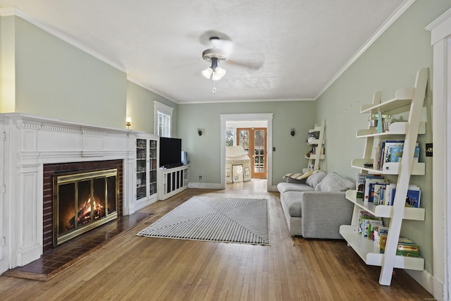 30 Cleveland Rd, New Haven, CT 06515 - living room featuring a ceiling fan, wood-type flooring, a fireplace, and ornamental molding