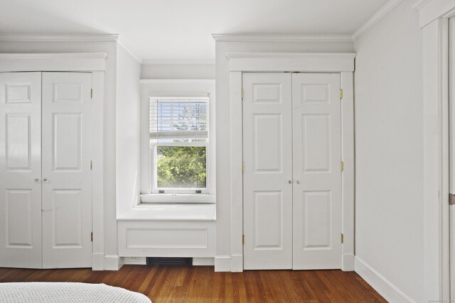 30 Cleveland Rd, New Haven, CT 06515 - unfurnished bedroom featuring dark wood-style floors, ornamental molding, and two closets