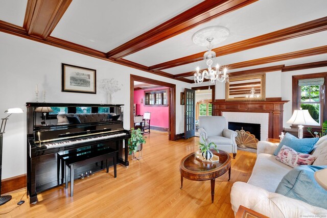 20 Arnoldale Rd, West Hartford, CT 06119 - living room featuring light wood-style flooring, baseboards, a chandelier, beamed ceiling, and ornamental molding