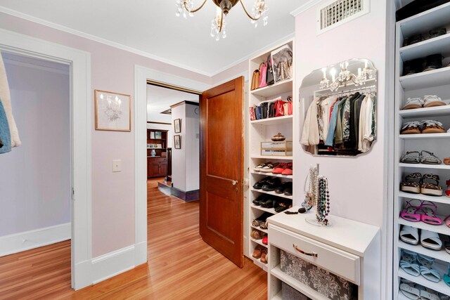 20 Arnoldale Rd, West Hartford, CT 06119 - corridor featuring a chandelier, light wood-style flooring, crown molding, and baseboards