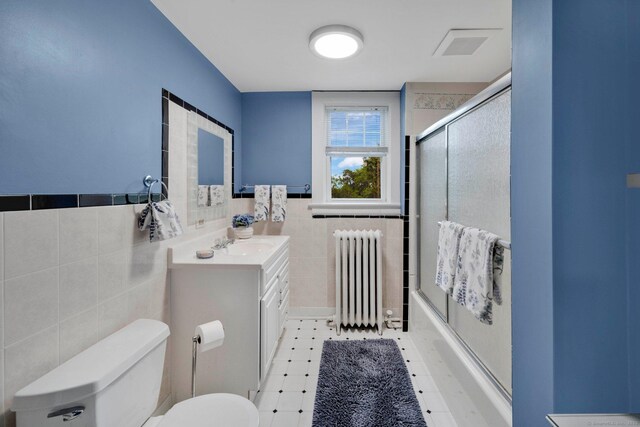 20 Arnoldale Rd, West Hartford, CT 06119 - bathroom with radiator heating unit, tile walls, toilet, vanity, and wainscoting