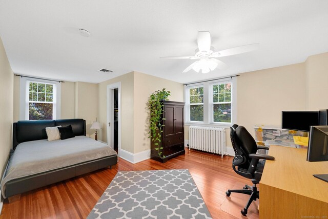 20 Arnoldale Rd, West Hartford, CT 06119 - bedroom with radiator heating unit, wood finished floors, an office area, baseboards, and a ceiling fan