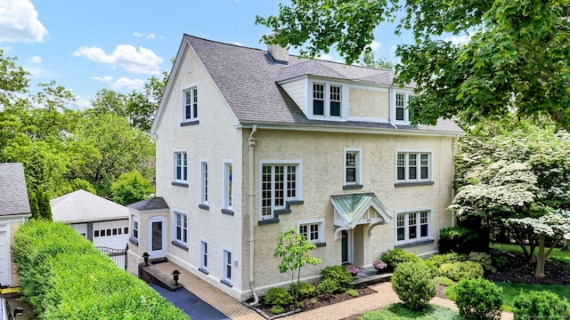 20 Arnoldale Rd, West Hartford, CT 06119 - view of front of property with stucco siding, an outdoor structure, and roof with shingles