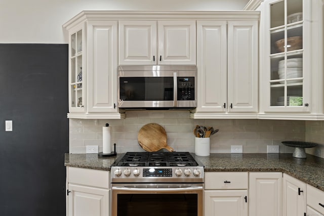 11 Quarry Ridge Rd, Newtown, CT 06482 - kitchen with appliances with stainless steel finishes, decorative backsplash, white cabinets, glass insert cabinets, and dark stone counters